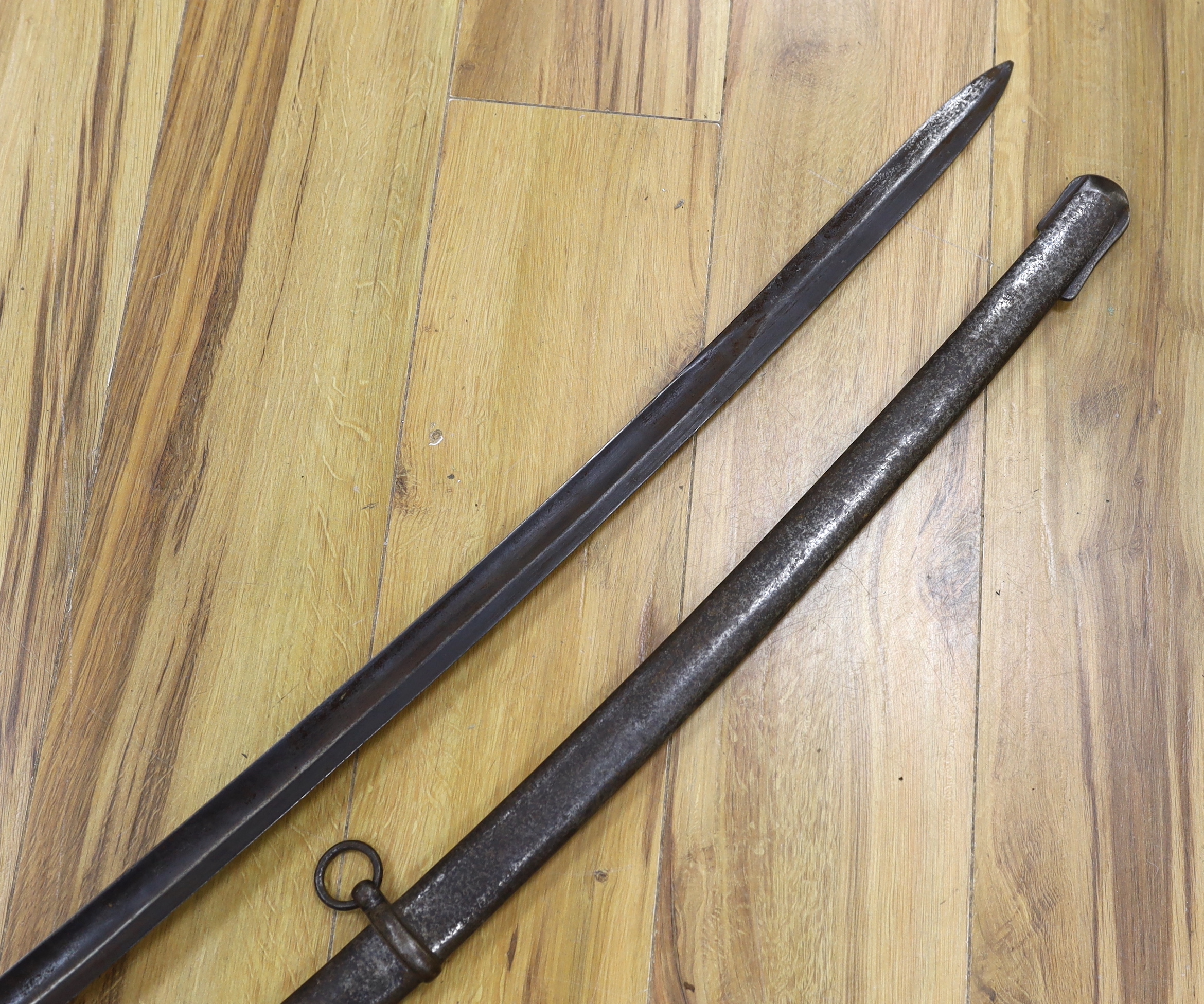 A pair of late 19th century German swords, one in its scabbard, together with another unrelated scabbard, made for the international arms trade, probably in Solingen, blade 89cm. Condition - fair, scabbards are 87cm and